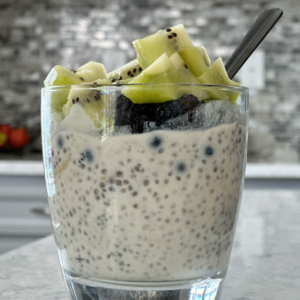 chia pudding in a cup with kiwi on top