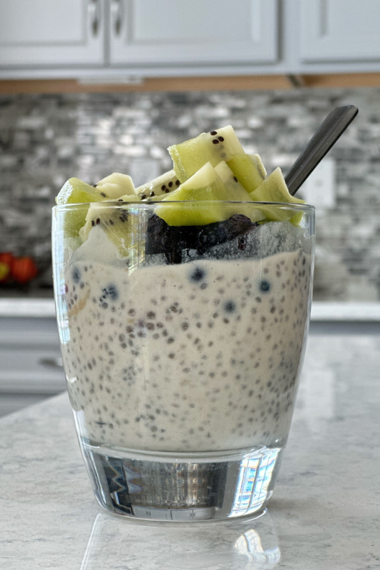 chia pudding in a cup with kiwi on top